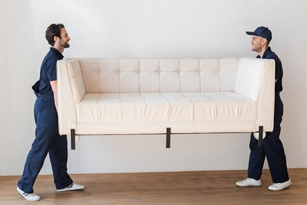 Professional movers carrying furniture